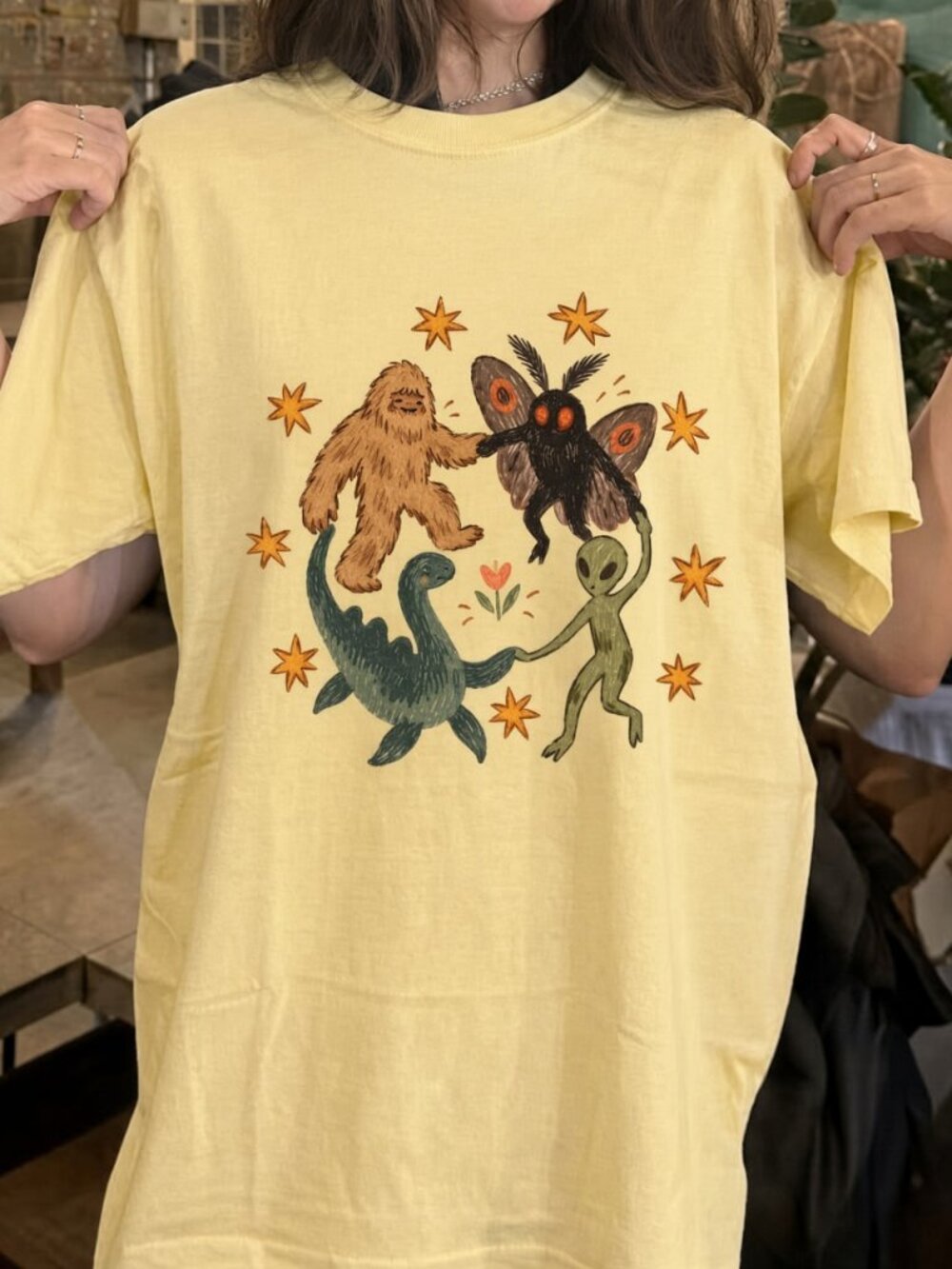 Cryptid Friends Graphic Tee Bigfoot Mothman Nessie Alien Dancing Shirt Yellow